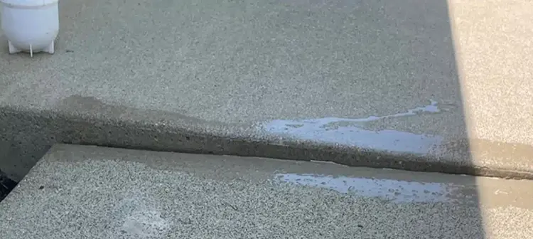 A sunken concrete slab that needs concrete lifting services for balancing it.