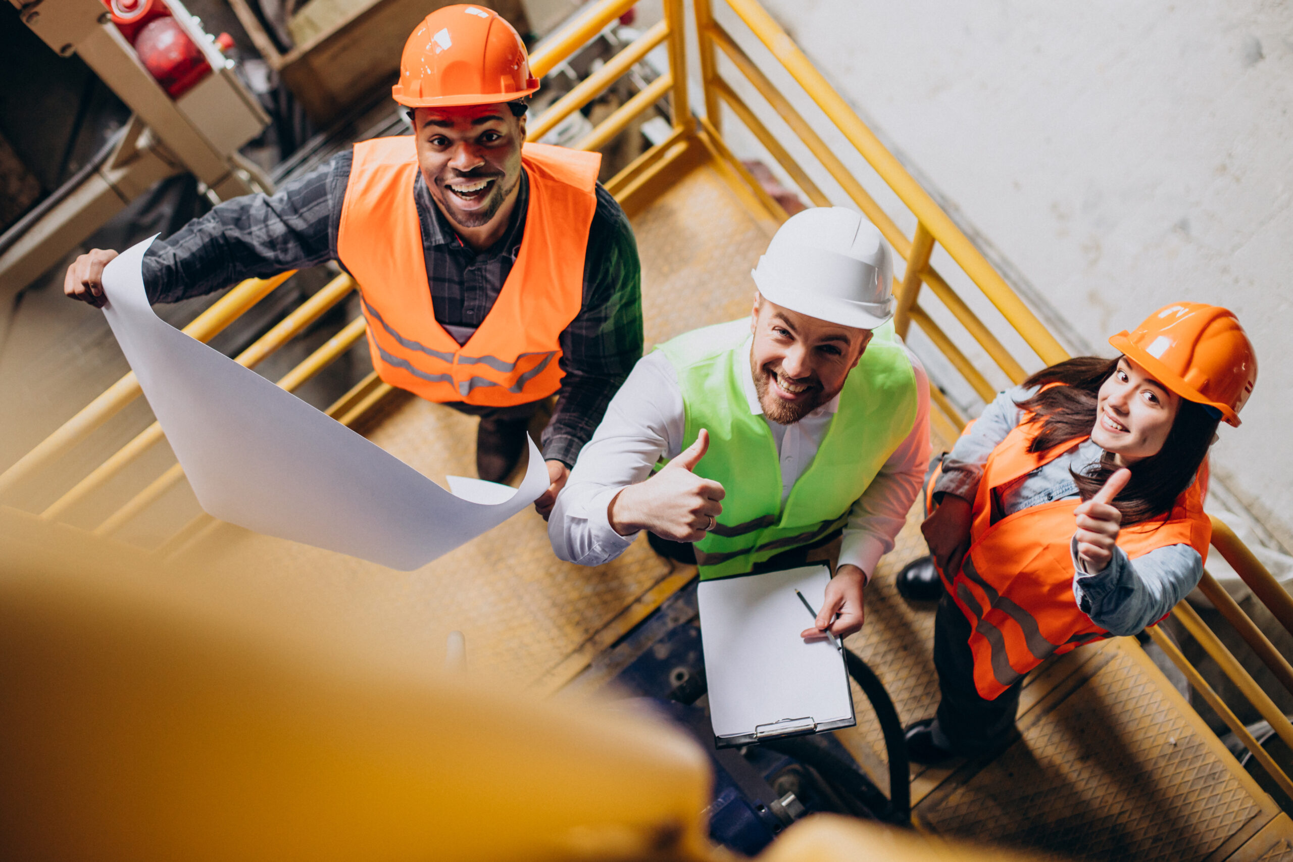 Fix Concrete Cracks - Three contractors in overalls smiling and giving a thumbs up.