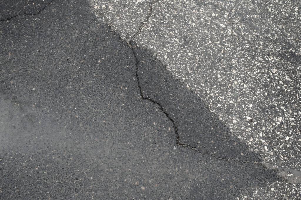 Sinking Concrete Repair - A Concrete Slab with a Crack in it and Uneven Sides