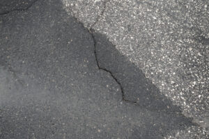 Mudjacking concrete leveling - A concrete slab with an uneven surface because of a crack