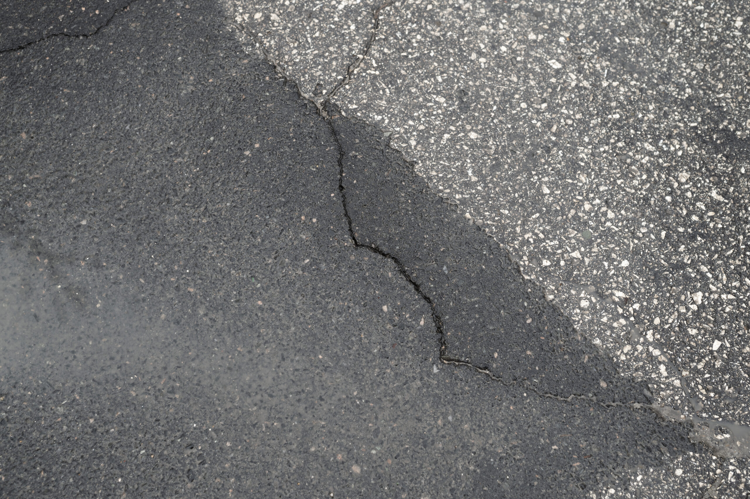 Sinking Concrete Repair - A Concrete Slab with a Crack in it and Uneven Sides