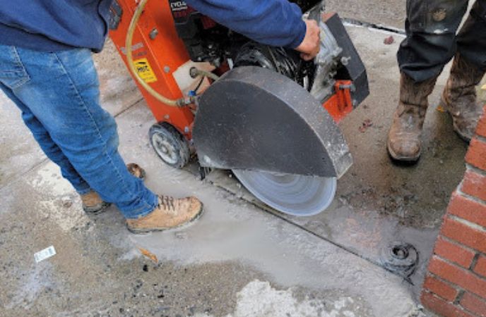 The team is busy at work to get access to the underside of the concrete to provide mudjacking services. 