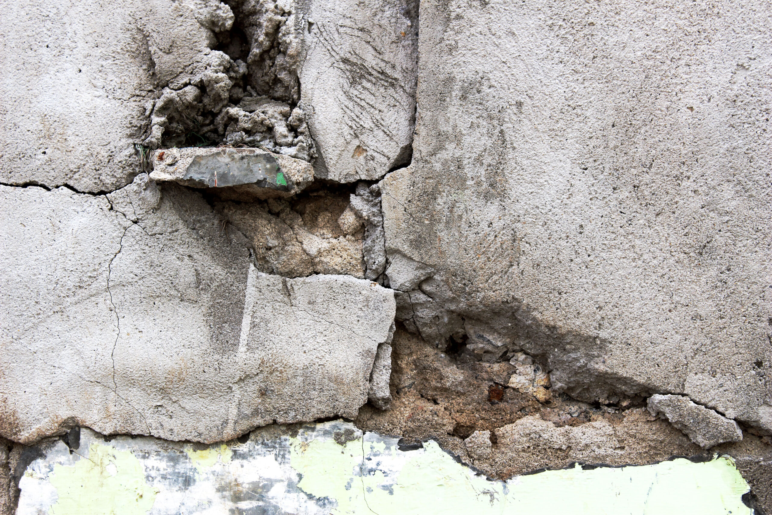 A closeup of a badly spalled concrete foundation in Queens, NY that The Mudjacking Contractor Team repaired.