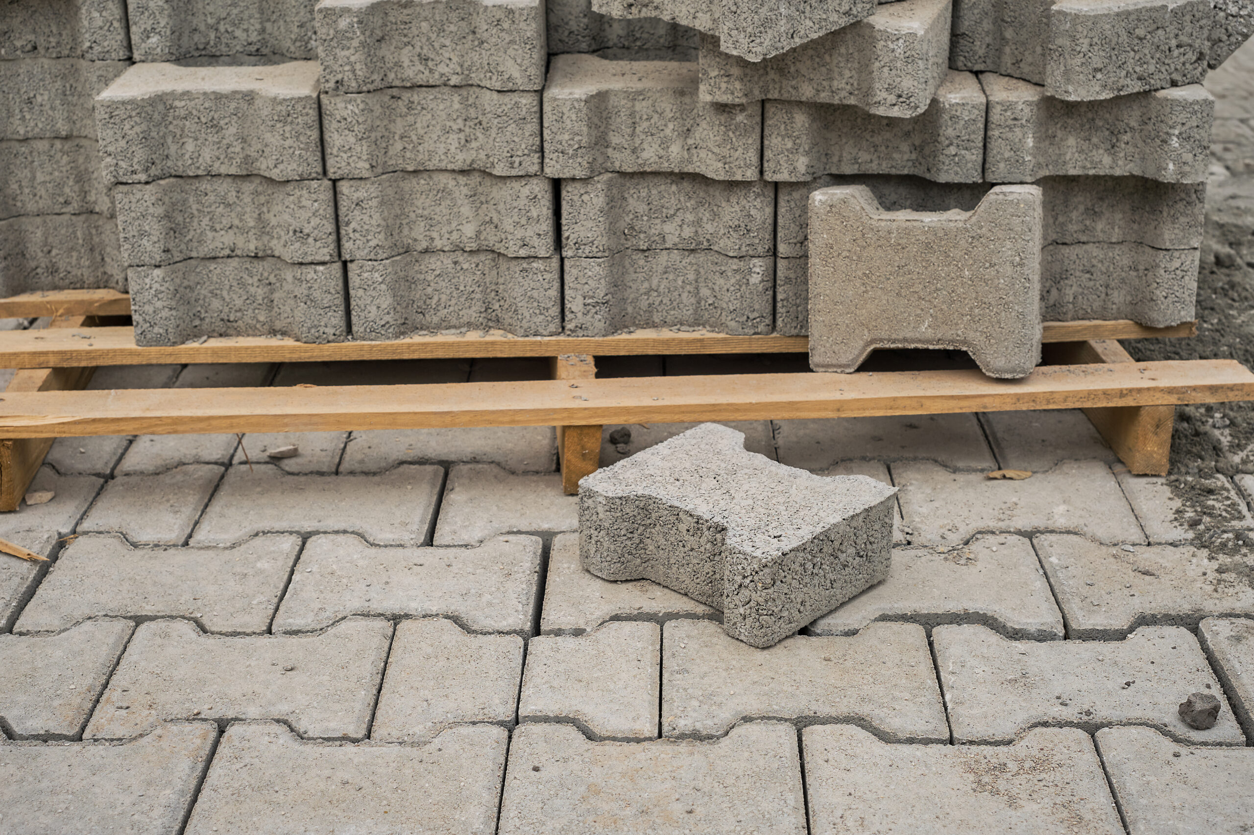 A closeup of stacked grey cellular lightweight concrete blocks set aside to use for construction