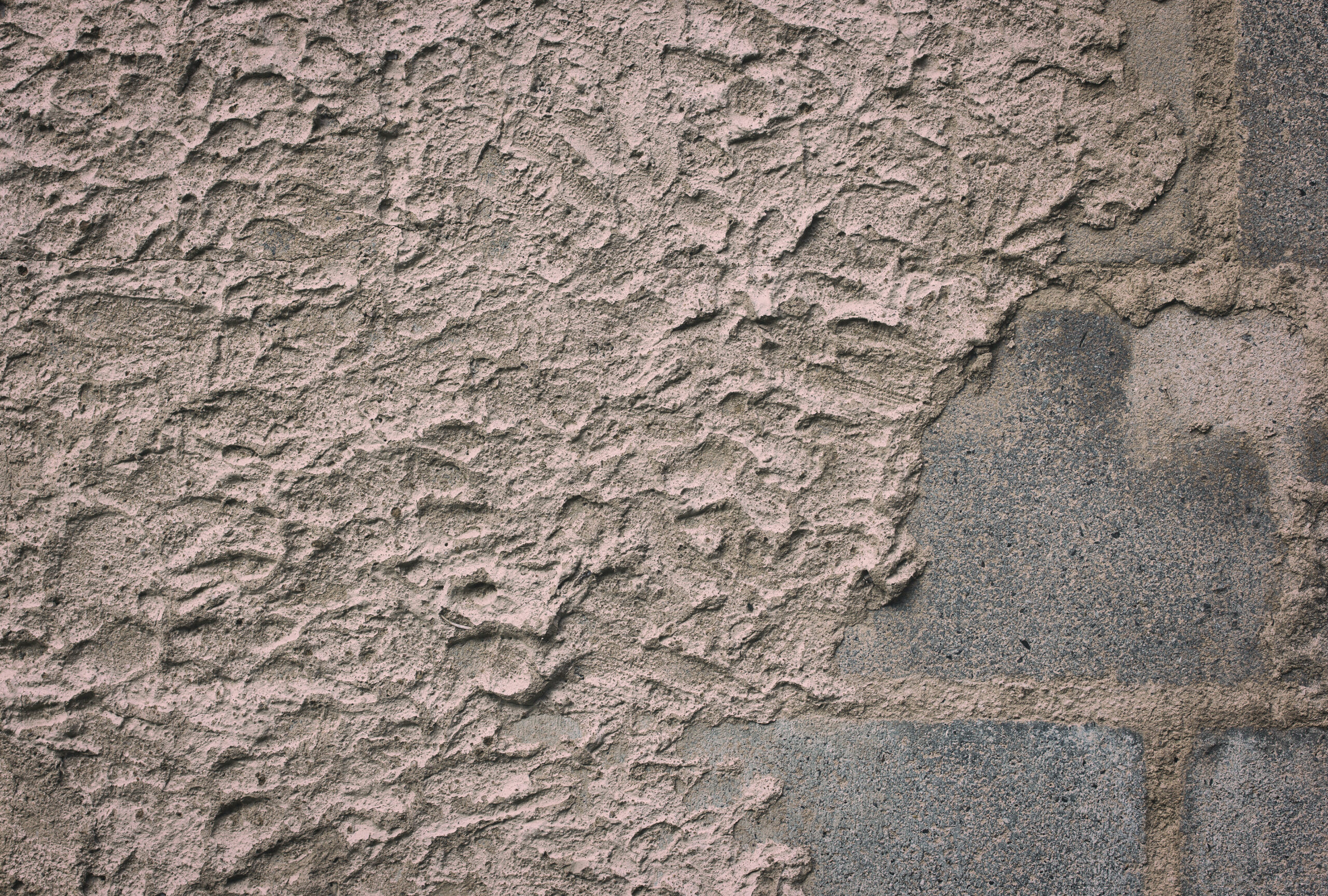 A concrete surface in grey in dire need of resurfacing