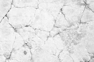 Cracks and debris on white concrete