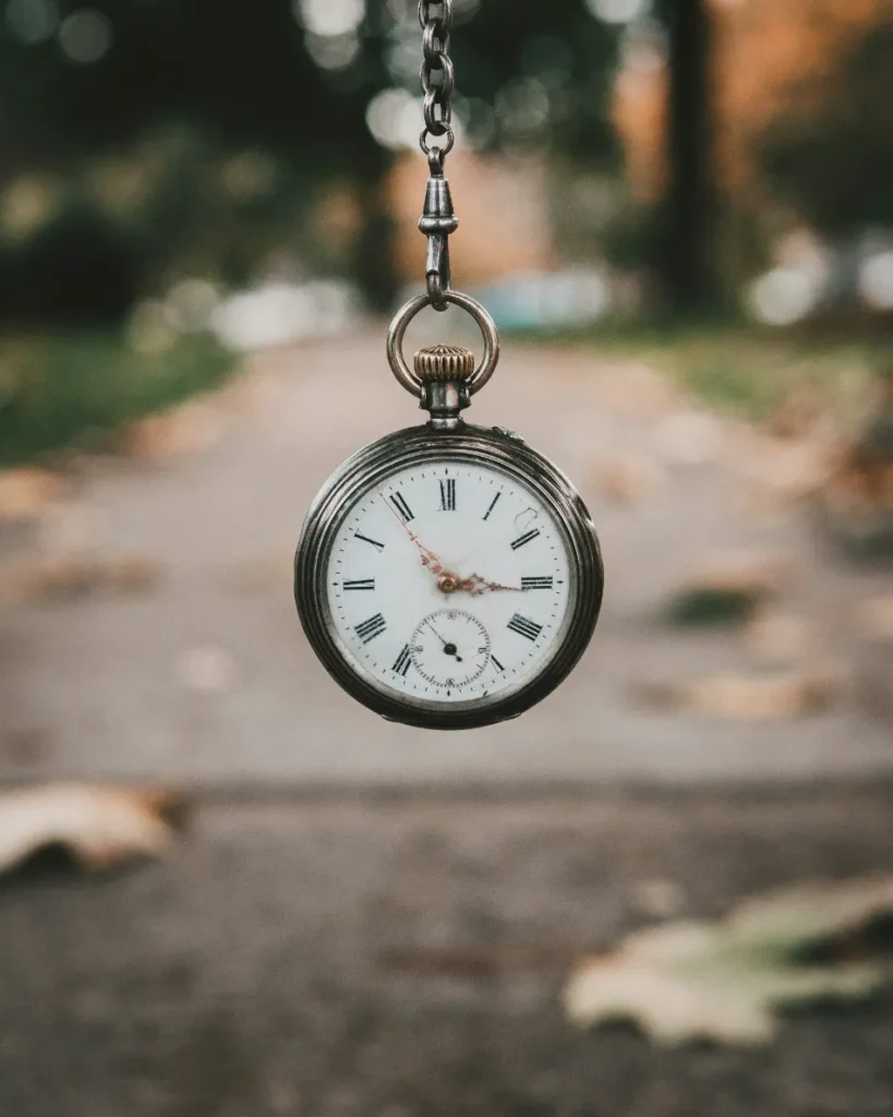 Does Concrete Lifting Last - A Picture of a Pocket Watch Held Above a Sidewalk