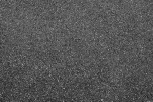 A close-up of an asphalt-textured driveway.