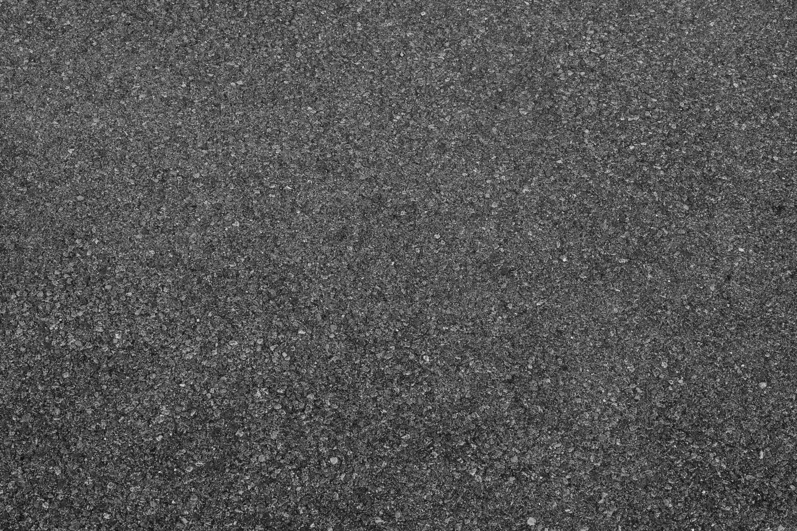 A close-up of an asphalt-textured driveway.