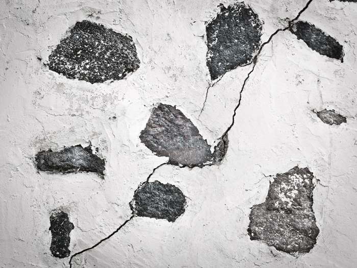 Chipped concrete surface with visible cracks