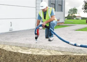 Concrete being lifted with a poly jacking foam with a contractor