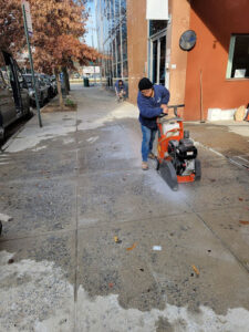 Contactor from the Mudjacking Contractor cutting the concrete that is damaged for concrete lifting