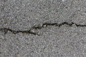 Cracked concrete surface with rocks