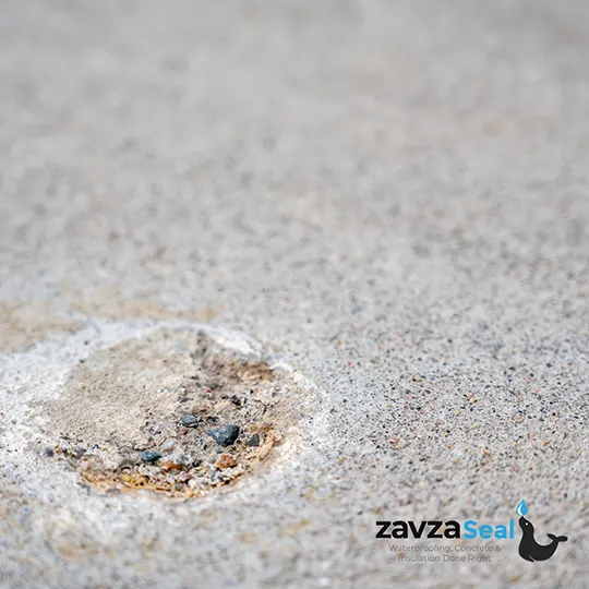 A hole that was drilled to fill it with polyjacking fluid