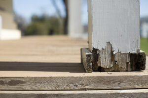 A porch that is pulling away from the house that shows damage.