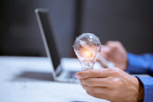 A light bulb with a laptop with innovative icon
