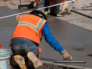 A contractor working on maintaining concrete for a property in NYC.