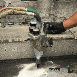 Polyjacking in progress with the machine nozzle in the concrete slab