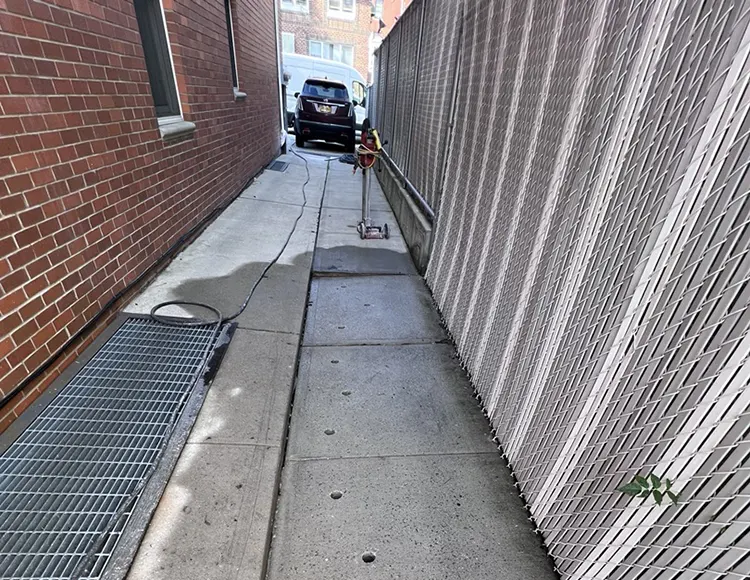 Sunken concrete sidewalk outside a property in Long Island, NY